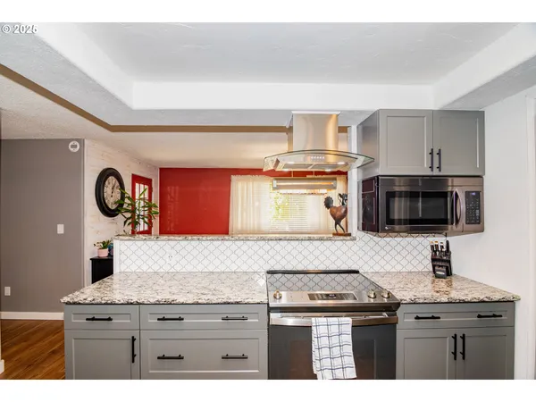 a kitchen with a stove and a microwave