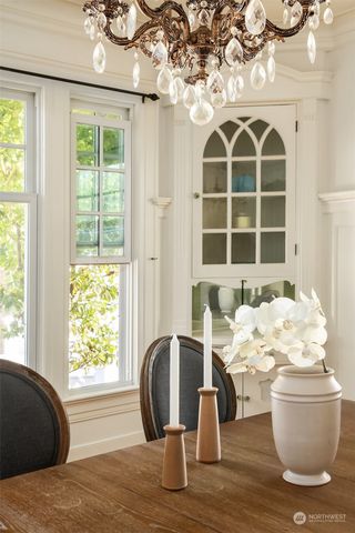 a dining room with furniture and chandelier