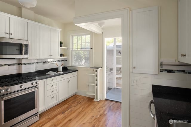 a kitchen with granite countertop a refrigerator and a sink