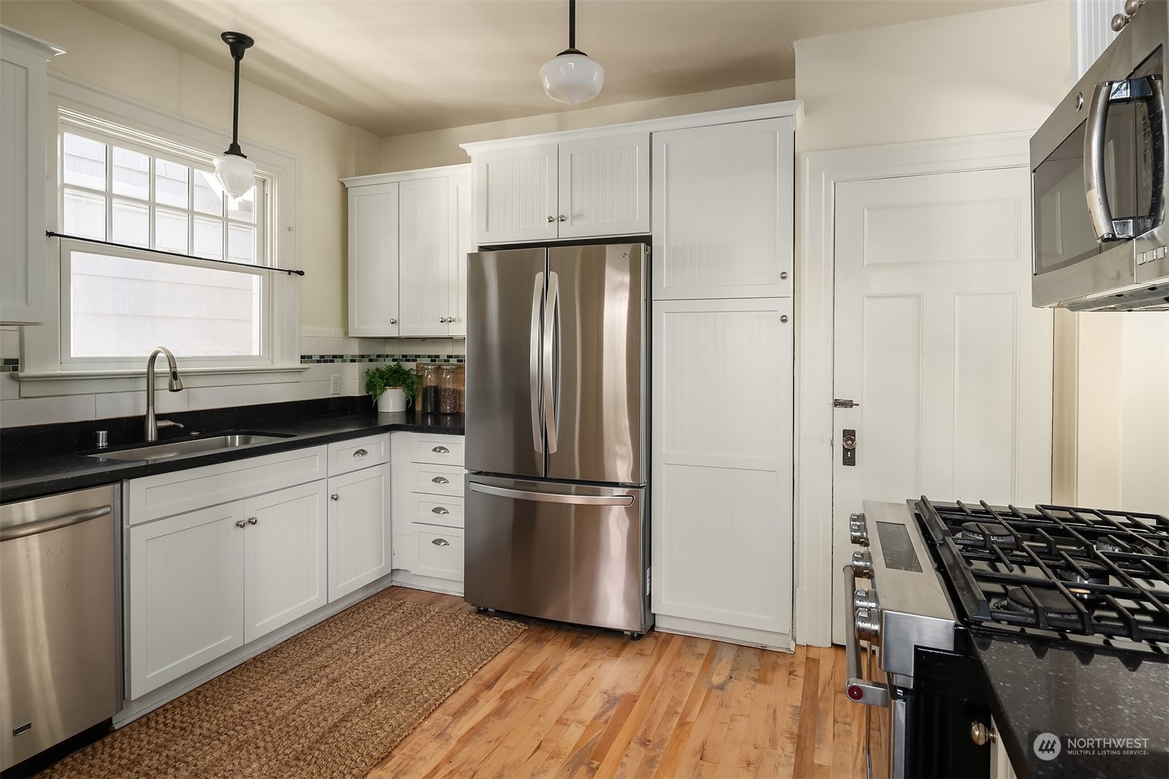 1505 North 43rd Street Seattle, WA 98103 - Photo 15 of 40 a kitchen with granite countertop a refrigerator and a sink