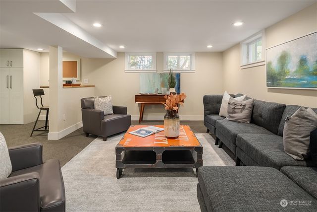a living room with furniture a couch and a potted plant