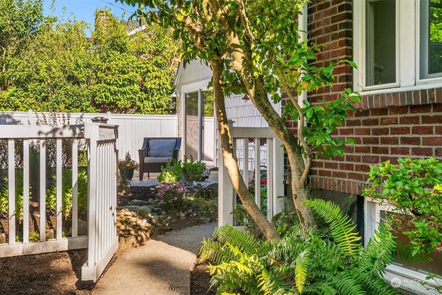 a living room with furniture a rug and white walls