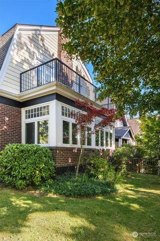 a view of a house with a small yard and wooden fence