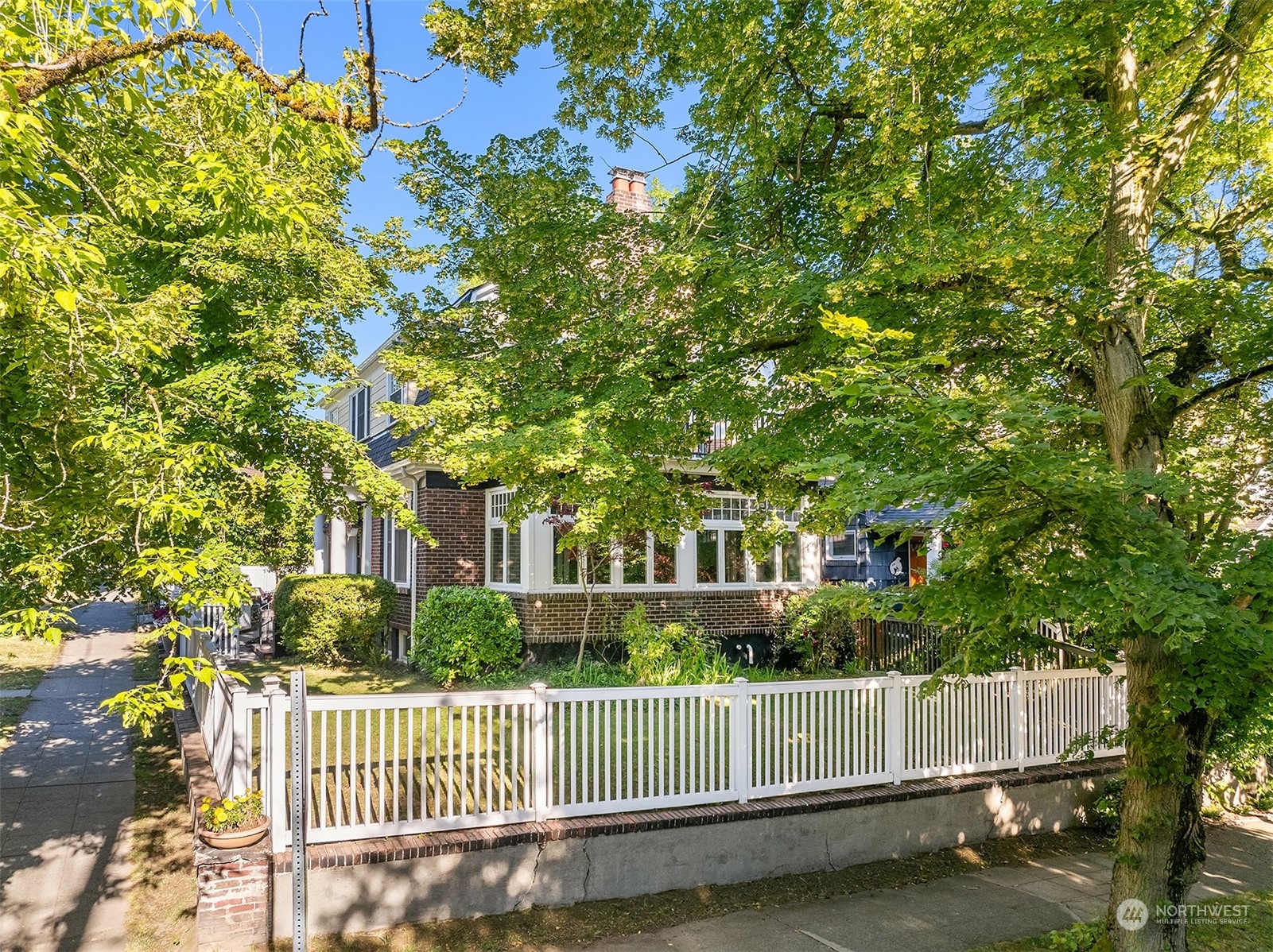 1505 North 43rd Street Seattle, WA 98103 - Photo 35 of 40 a view of a house with a small yard and wooden fence