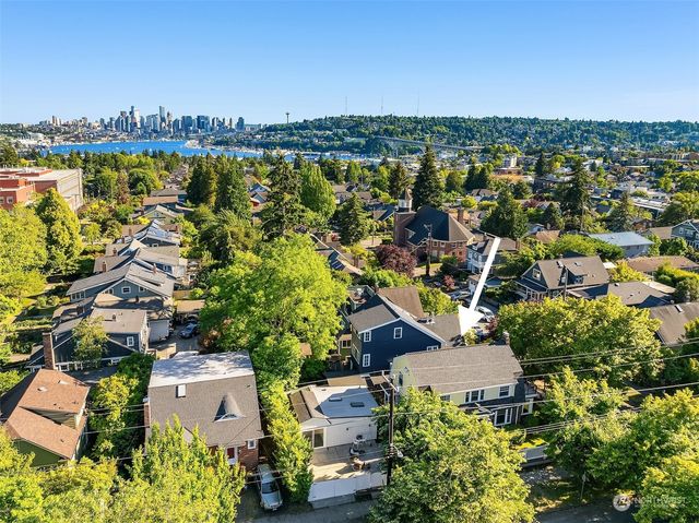 an aerial view of residential houses with outdoor space and trees