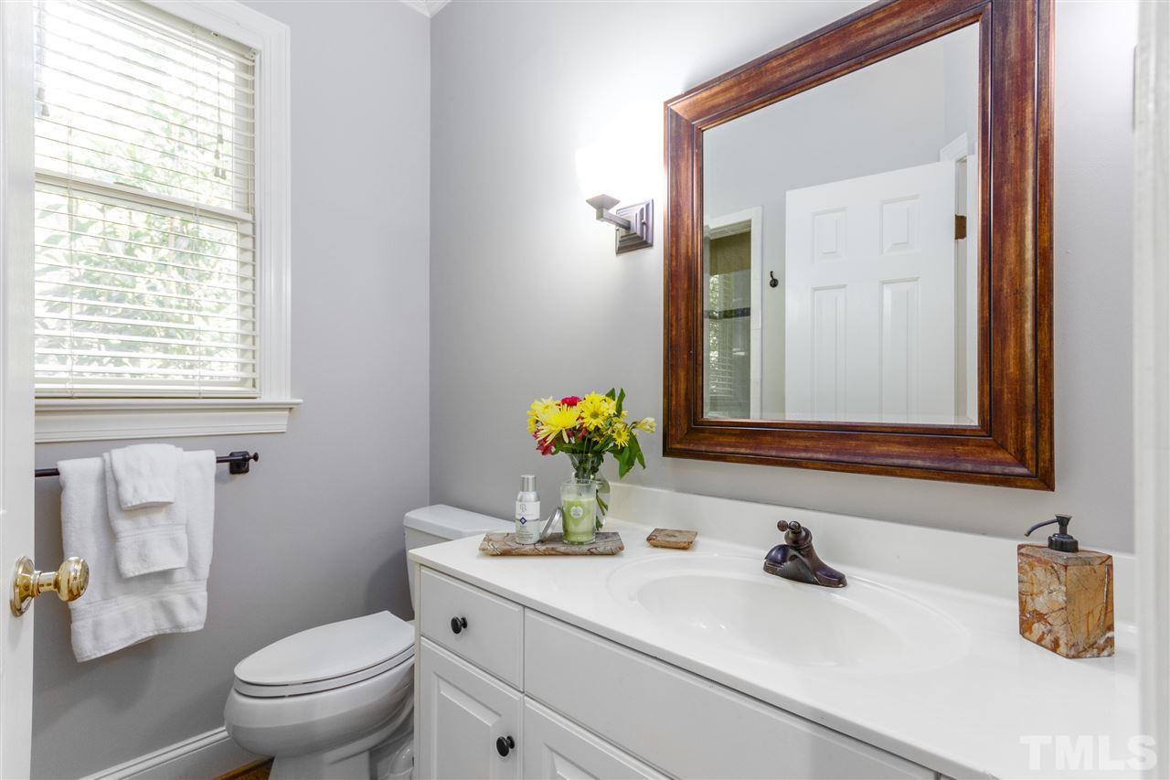 3424 Doyle Road Raleigh, NC 27607 - Photo 14 of 25 a bathroom with a sink a toilet and a mirror