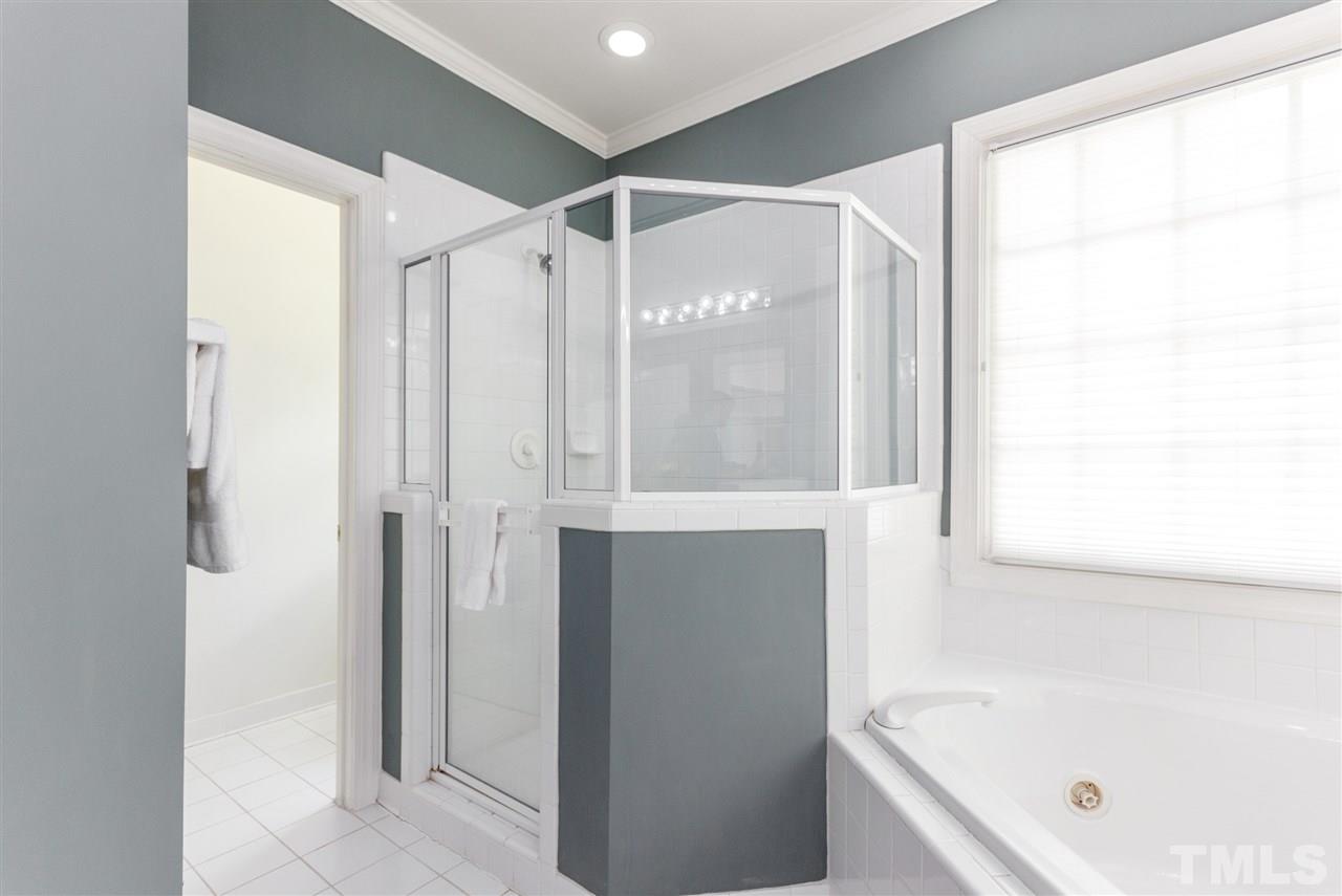 3424 Doyle Road Raleigh, NC 27607 - Photo 21 of 25 a bathroom with a bathtub and a shower