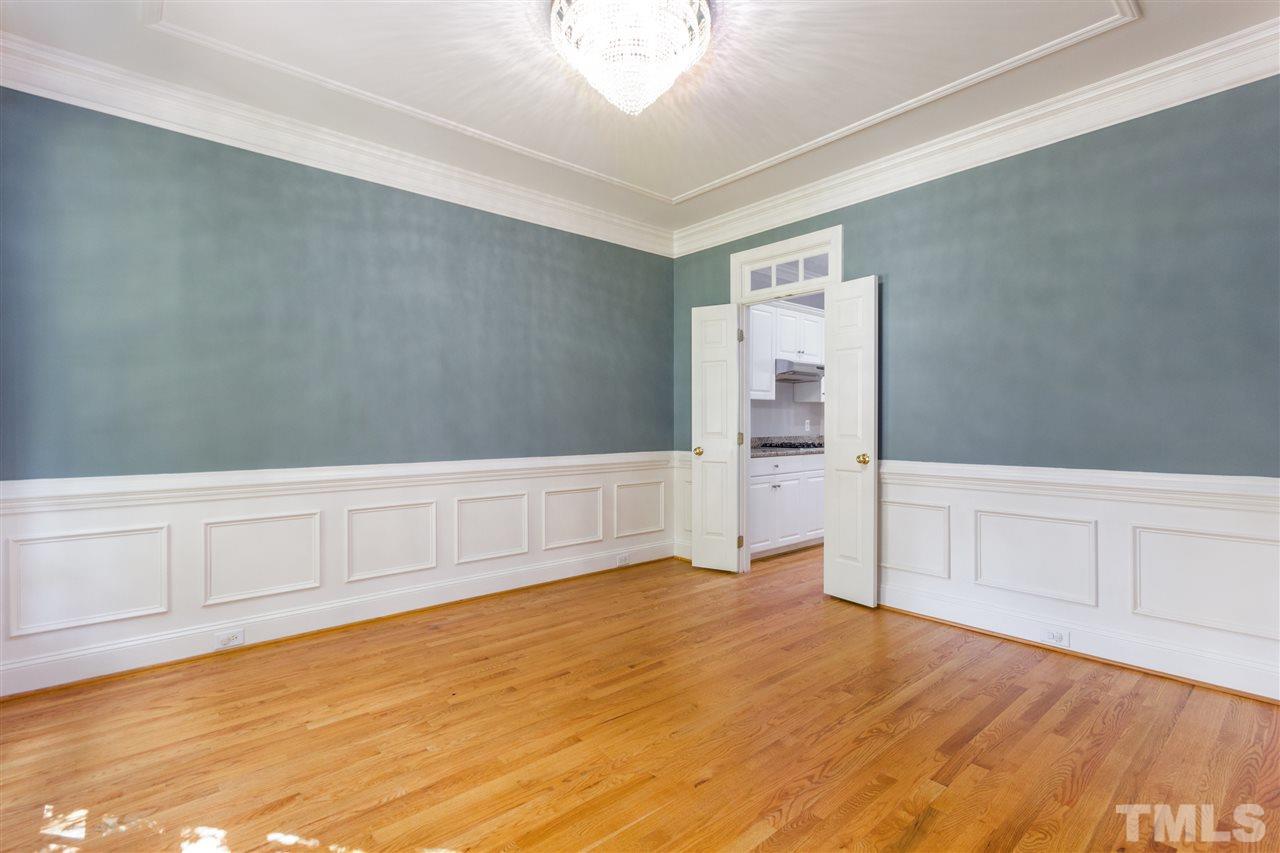 3424 Doyle Road Raleigh, NC 27607 - Photo 8 of 25 a view of an empty room with wooden floor