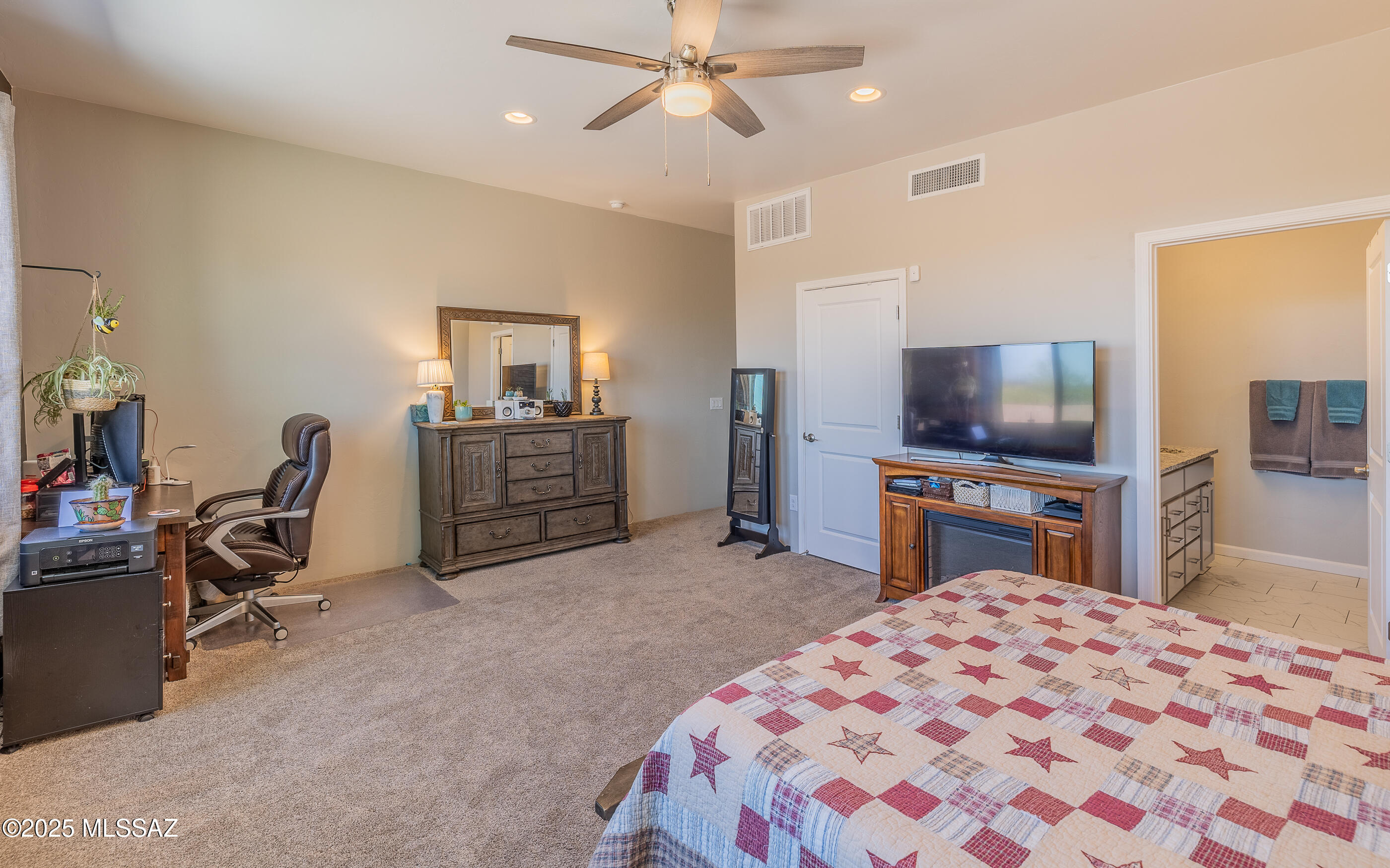 12123 Creosote Valley Road Vail, AZ 85641 - Photo 20 of 46 a bedroom with a bed and a flat screen tv