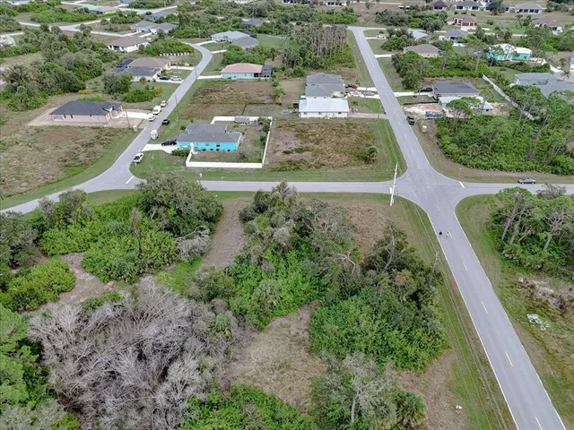 an aerial view of residential houses with outdoor space and street view