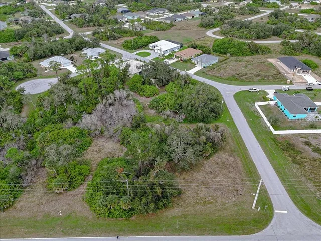 an aerial view of a house with a yard basket ball court and outdoor seating