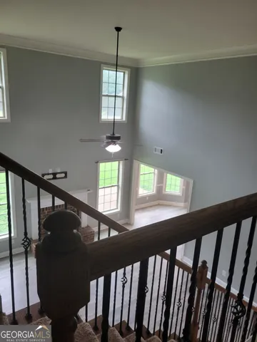 a view of entryway and hall with wooden floor