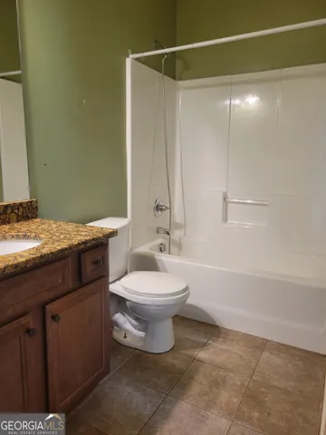 a bathroom with a toilet a sink and bathtub