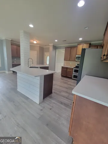 a view of kitchen with sink microwave and cabinets