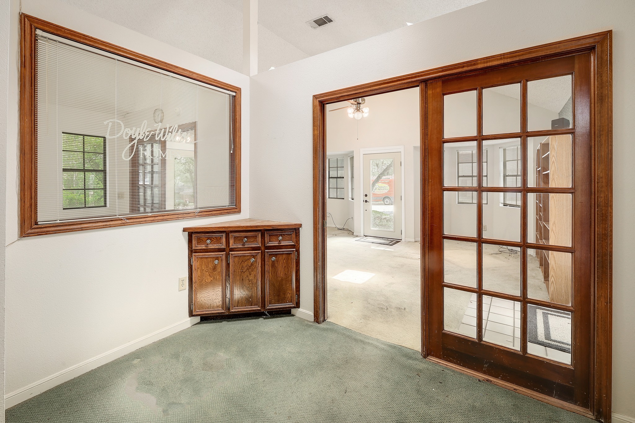 2202 Warfield Way Austin, TX 78728 - Photo 20 of 32 A well-lit study with a built-in cabinet offers an inviting workspace, framed by glass-paned French doors.