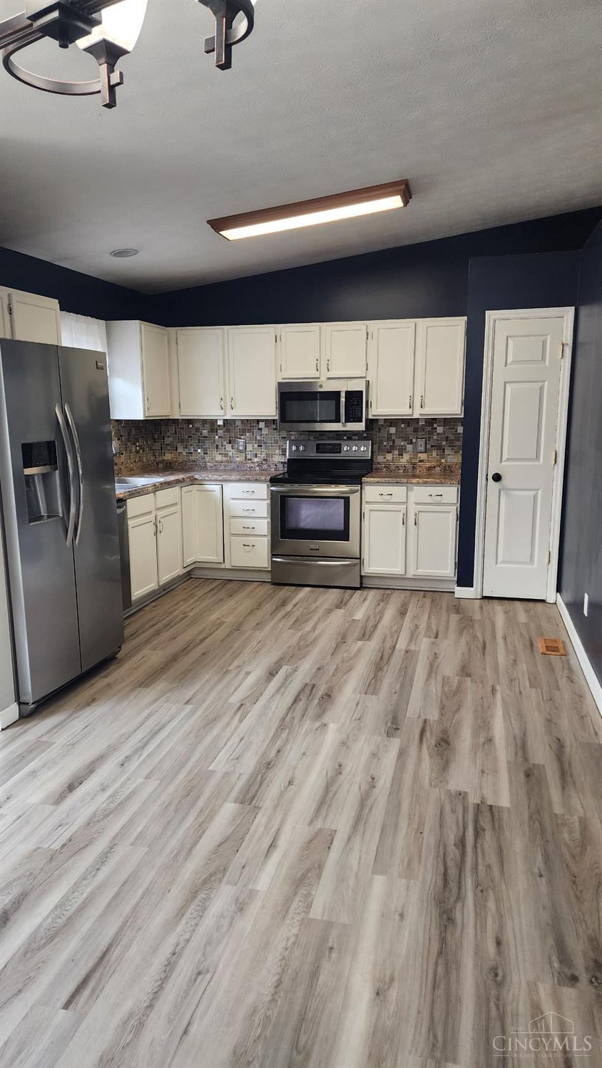 707 Hummingbird Way Maineville, OH 45039 - Photo 5 of 24 Kitchen has a newer tile backsplash and newer countertops. Also a small pantry!