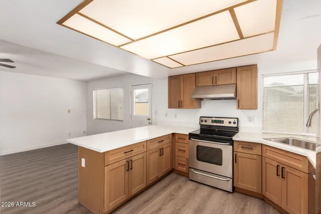 a large white kitchen with a large window