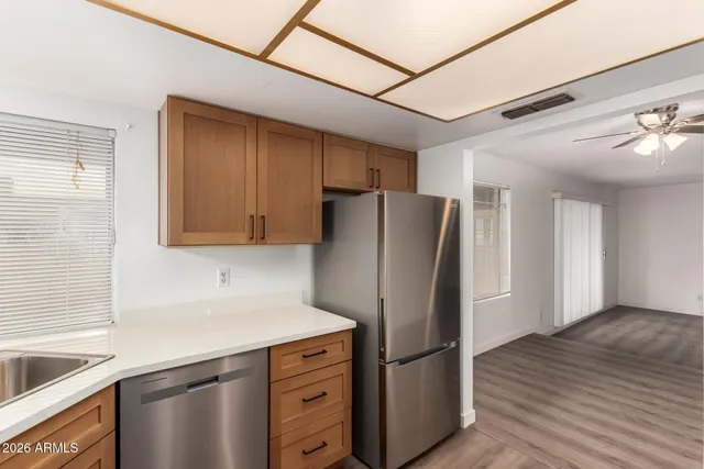 a kitchen with white cabinets and white appliances