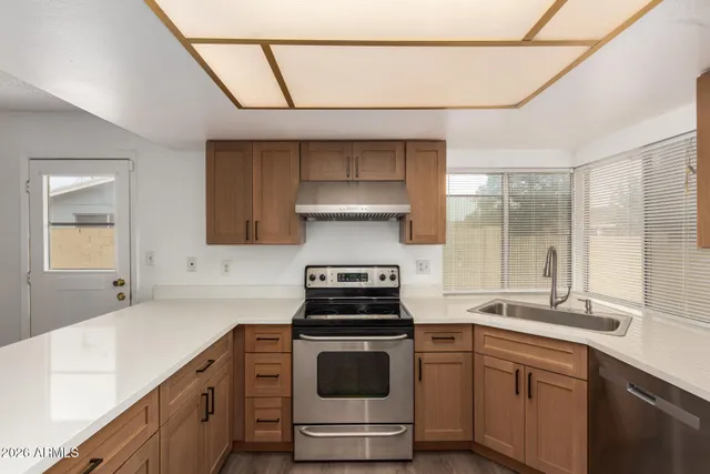 a kitchen with stainless steel appliances granite countertop a refrigerator and a sink