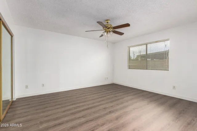 a kitchen with stainless steel appliances a stove and white cabinets