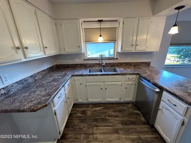 a kitchen with a sink stove and cabinets