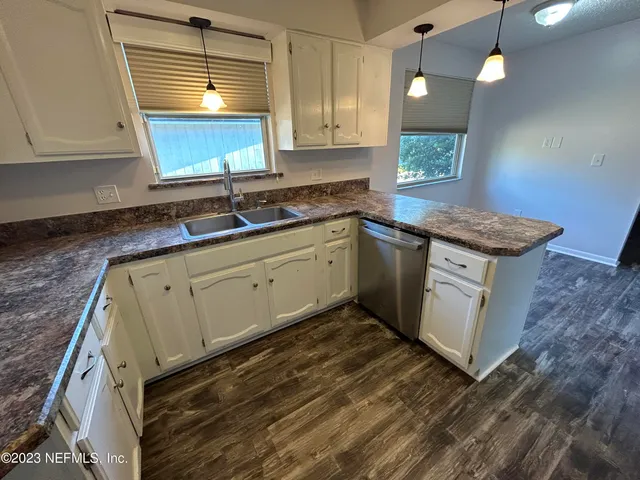 a kitchen with granite countertop a sink and a stove