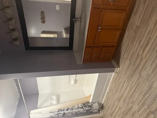 a bathroom with a bathtub a sink and a shower