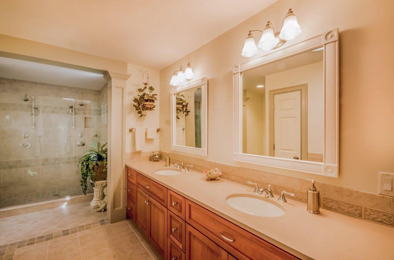 144 Tonset Road Orleans, MA 02653 - Photo 16 of 37 a bathroom with a sink double vanity granite tub shower and a mirror