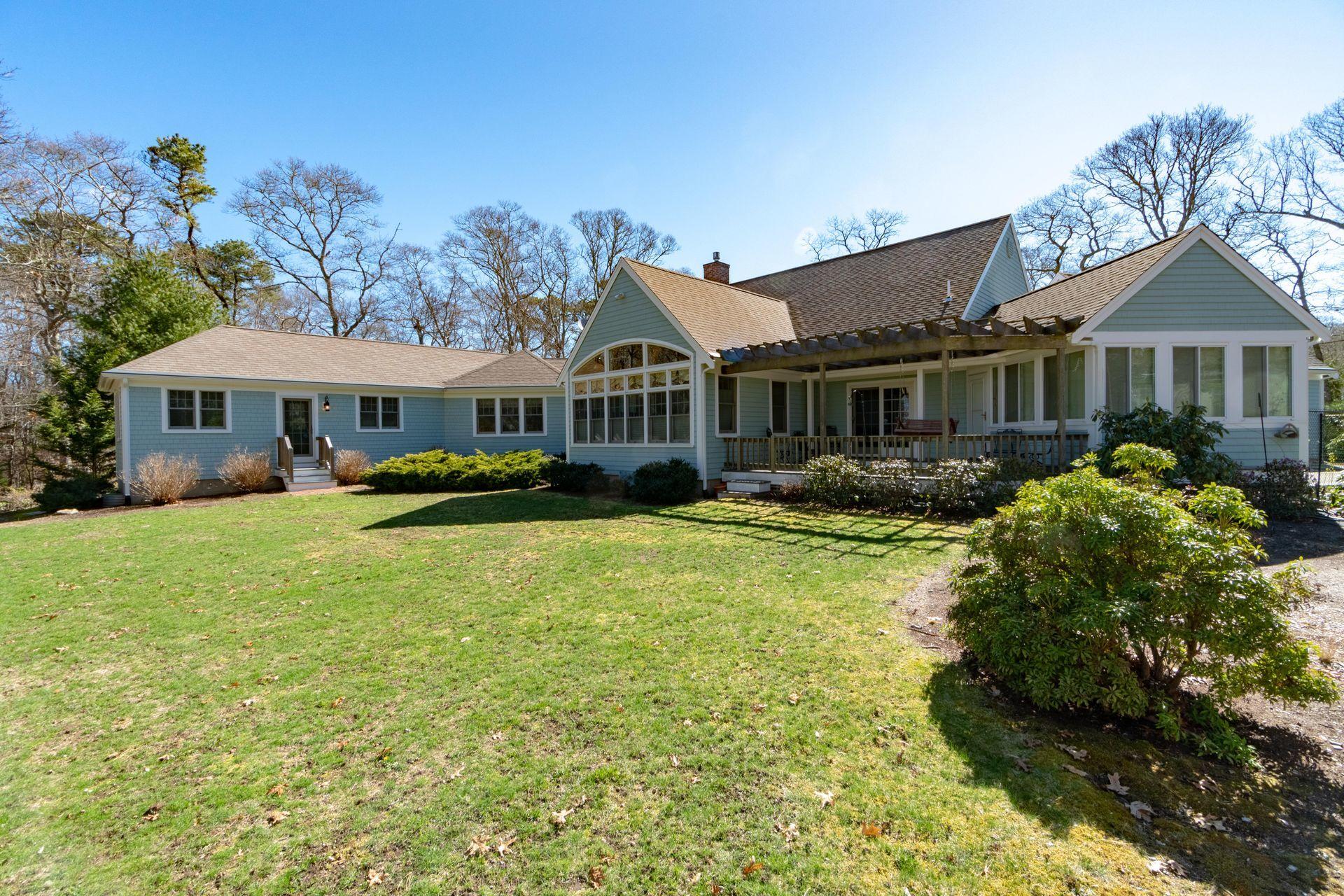 144 Tonset Road Orleans, MA 02653 - Photo 2 of 37 a front view of a house with swimming pool having outdoor seating