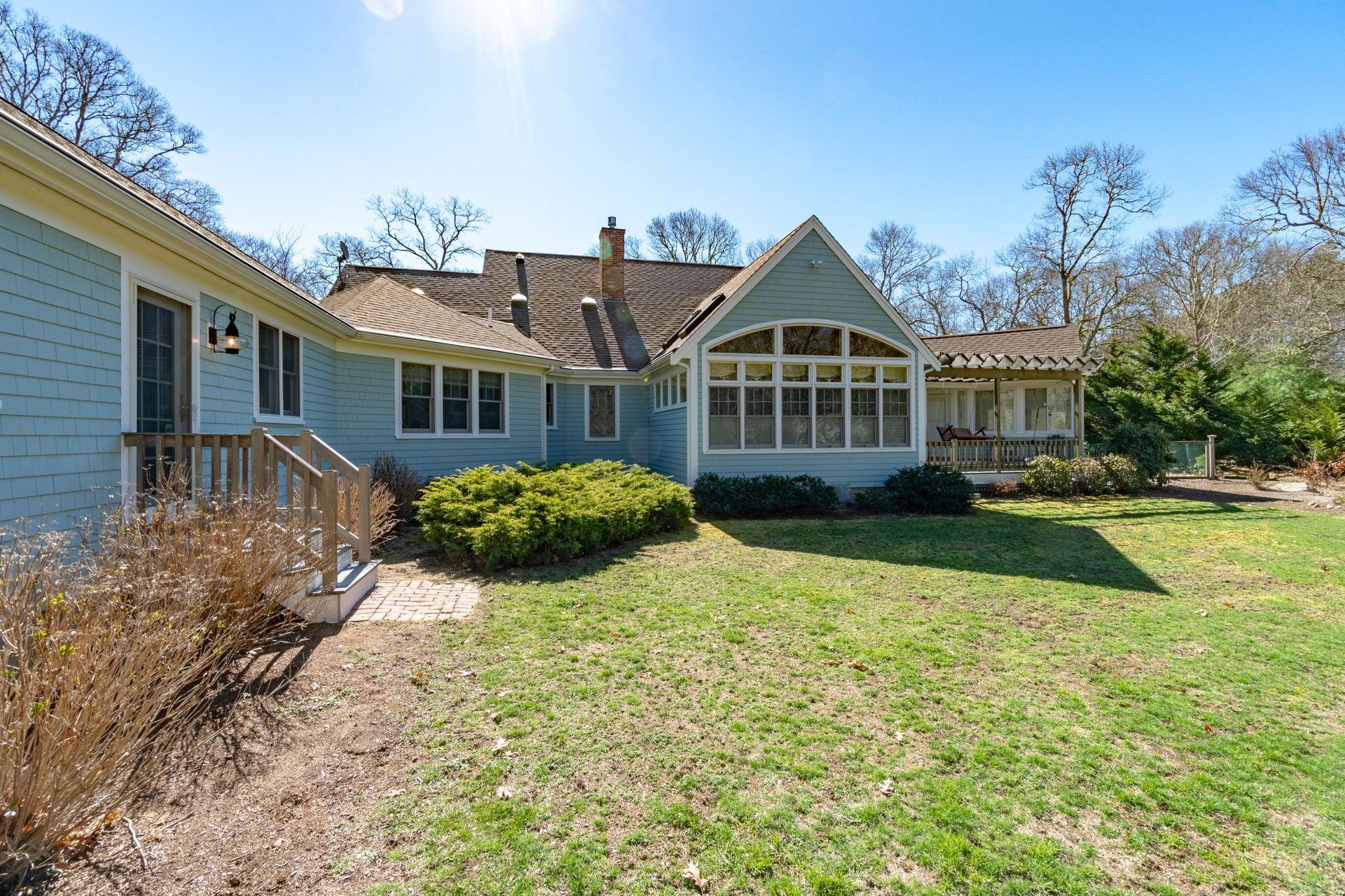 144 Tonset Road Orleans, MA 02653 - Photo 3 of 37 a front view of a house with yard and green space