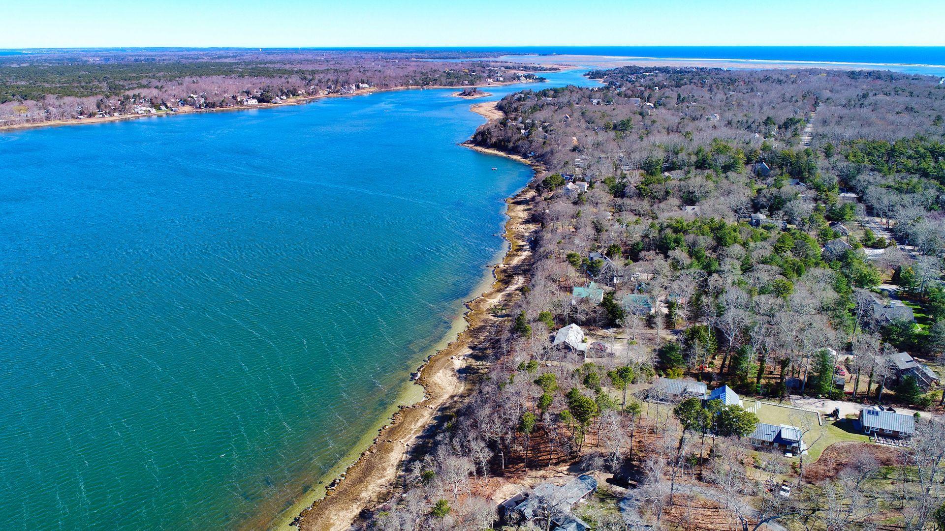 144 Tonset Road Orleans, MA 02653 - Photo 6 of 37 a view of a lake with a mountain