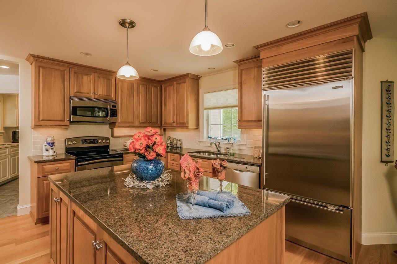 144 Tonset Road Orleans, MA 02653 - Photo 7 of 37 a kitchen with a refrigerator a stove and a sink