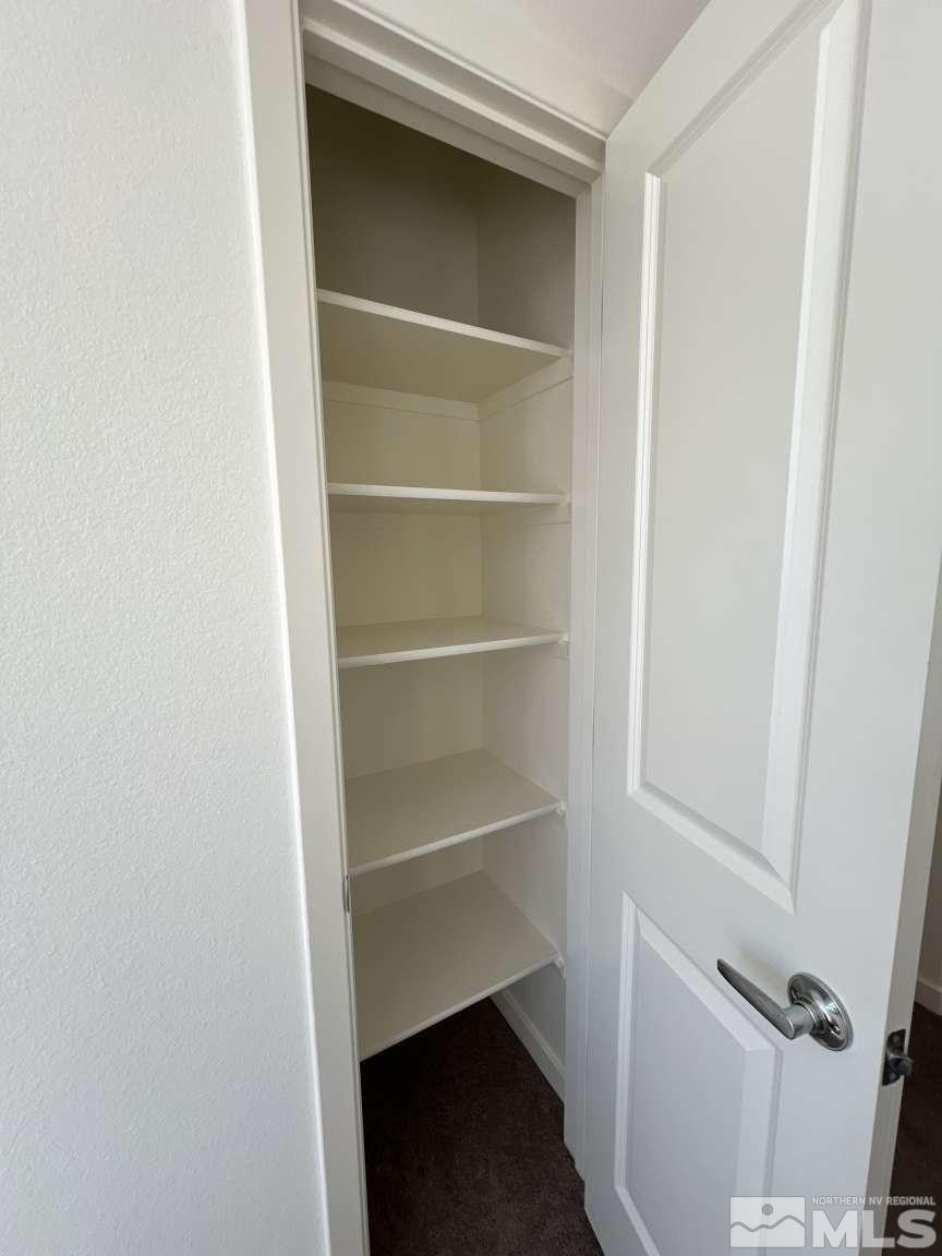 4880 Little Rock Way Sun Valley, NV 89433 - Photo 12 of 30 a view of walk in closet with empty racks