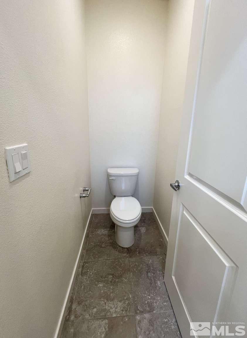 4880 Little Rock Way Sun Valley, NV 89433 - Photo 16 of 30 a white toilet sitting next to a white cabinet