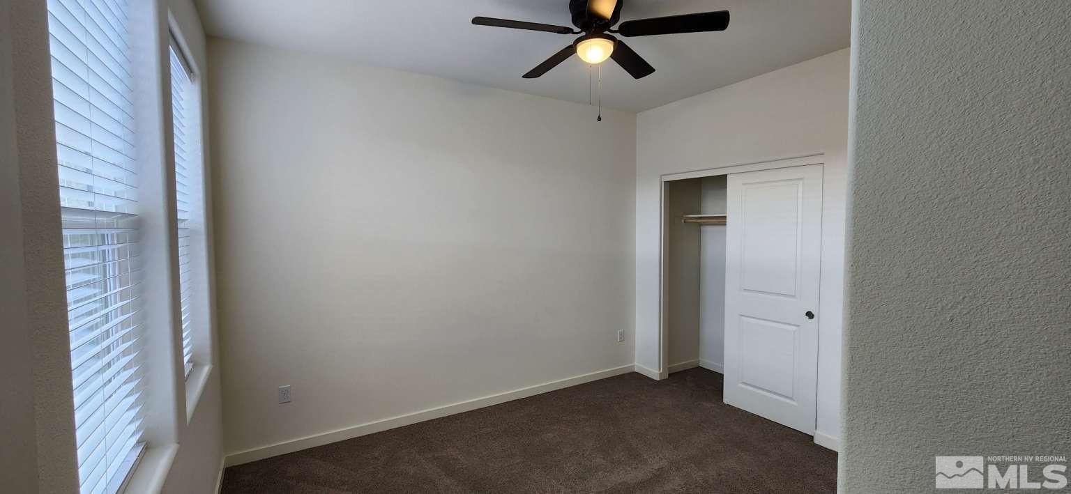 4880 Little Rock Way Sun Valley, NV 89433 - Photo 19 of 30 a view of a hallway with a ceiling fan