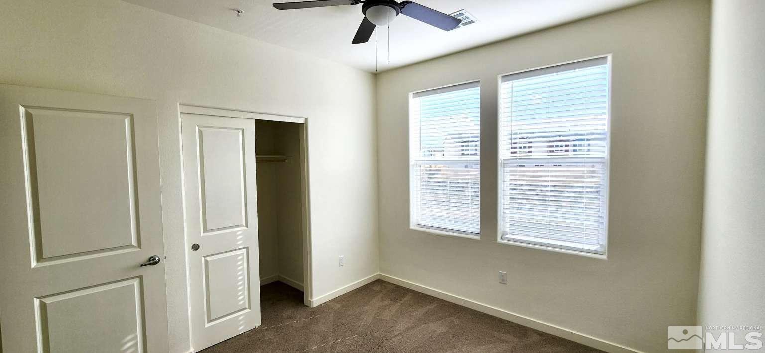 4880 Little Rock Way Sun Valley, NV 89433 - Photo 20 of 30 an empty room with a window and a ceiling fan