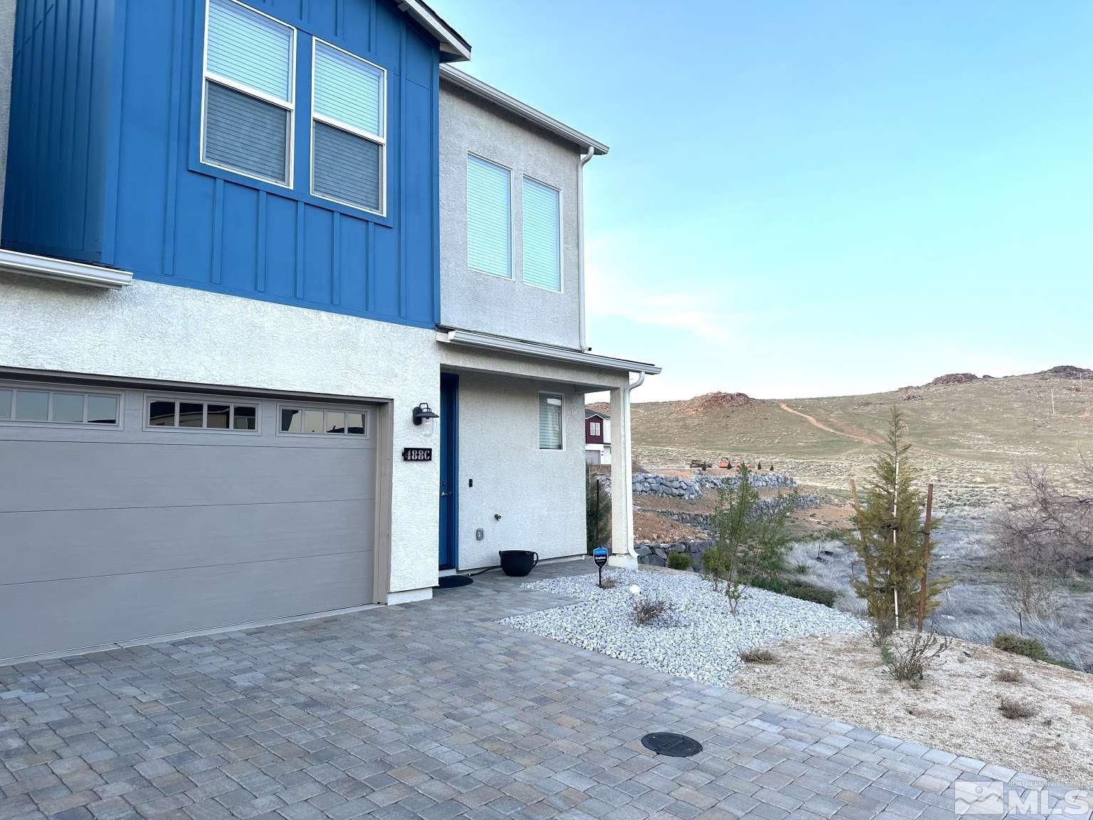 4880 Little Rock Way Sun Valley, NV 89433 - Photo 2 of 30 a view of a house with a backyard
