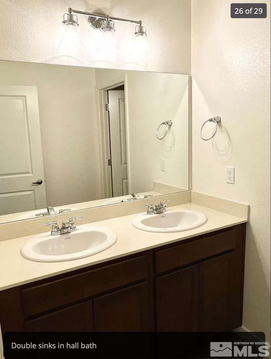 4880 Little Rock Way Sun Valley, NV 89433 - Photo 21 of 30 a bathroom with a sink and a mirror