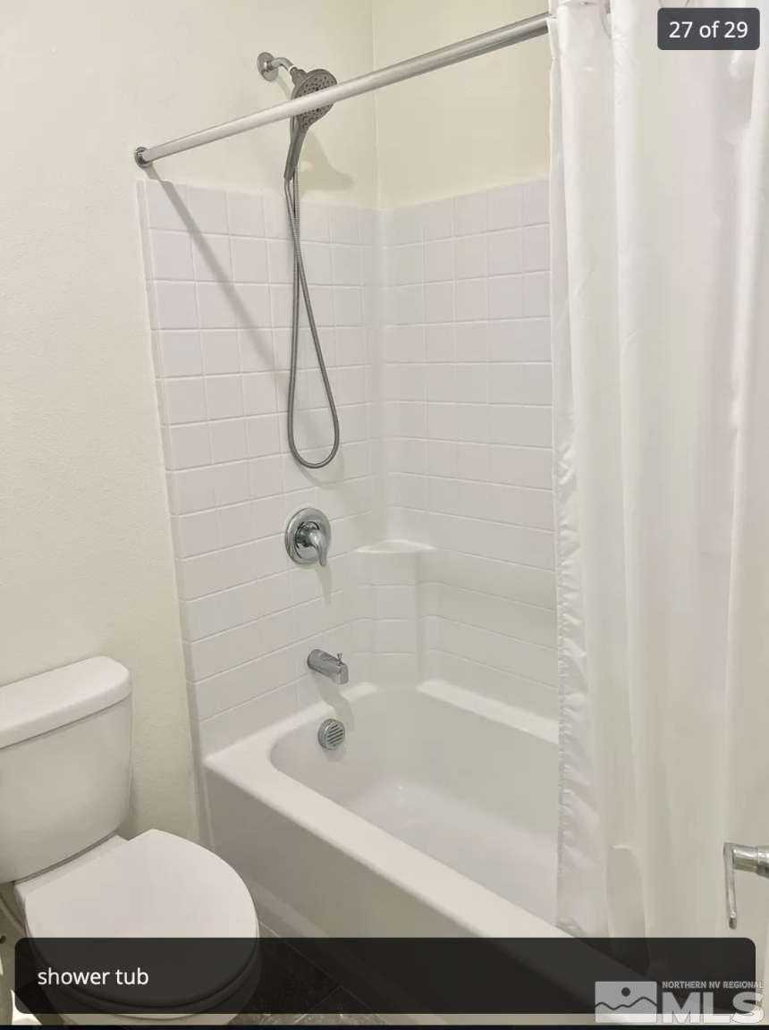 4880 Little Rock Way Sun Valley, NV 89433 - Photo 22 of 30 a bathroom with a shower and a toilet