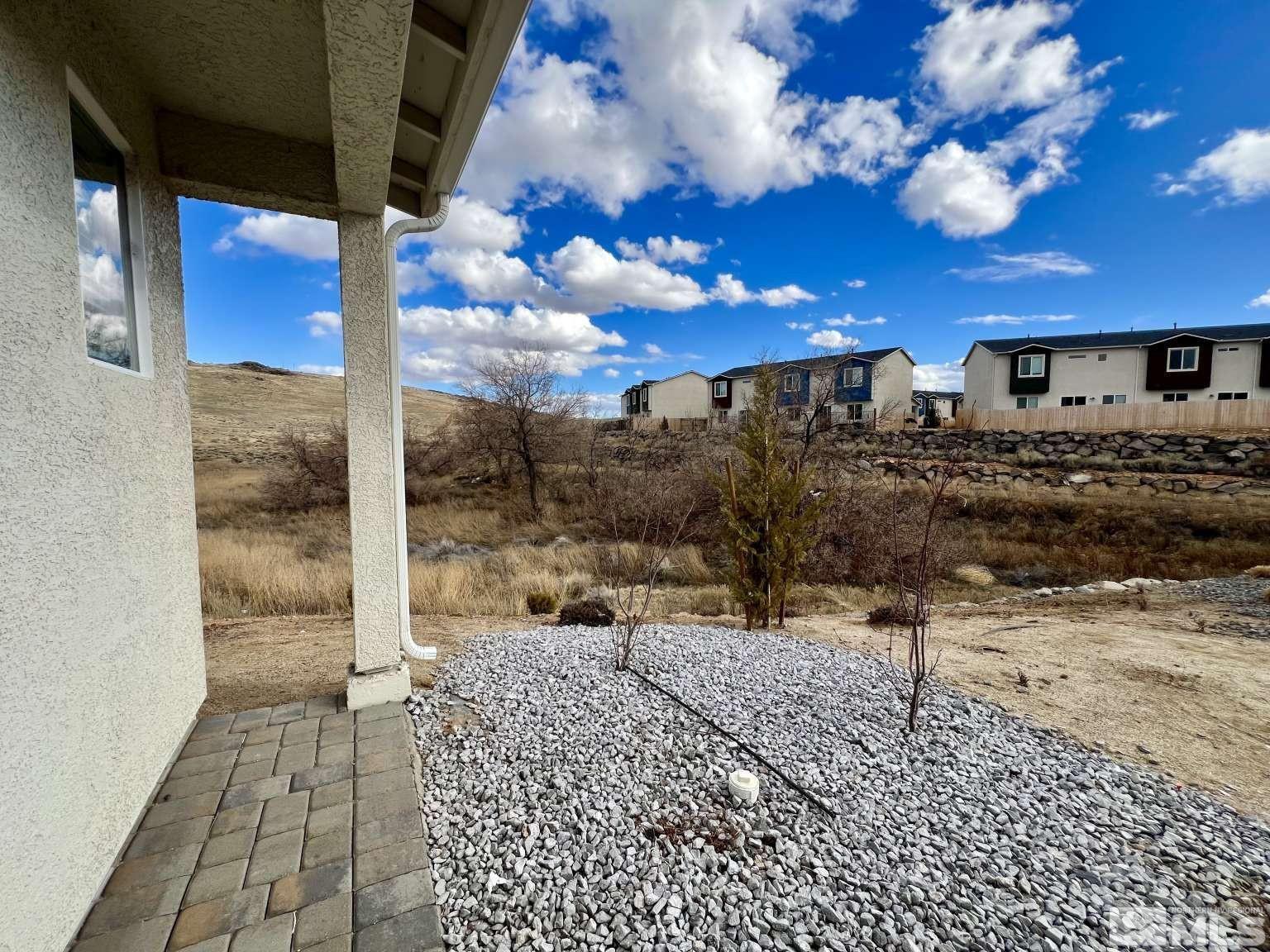 4880 Little Rock Way Sun Valley, NV 89433 - Photo 23 of 30 a view of a patio with a table and chairs under an umbrella
