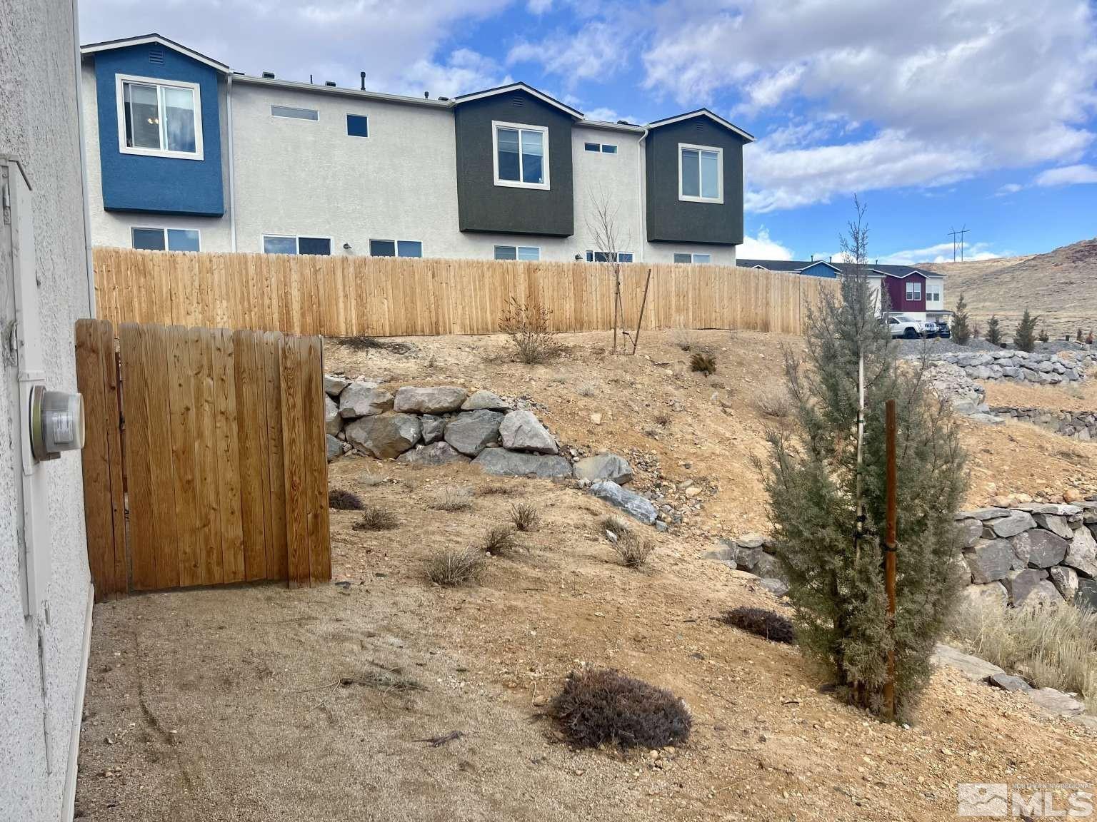 4880 Little Rock Way Sun Valley, NV 89433 - Photo 24 of 30 a view of house with a yard