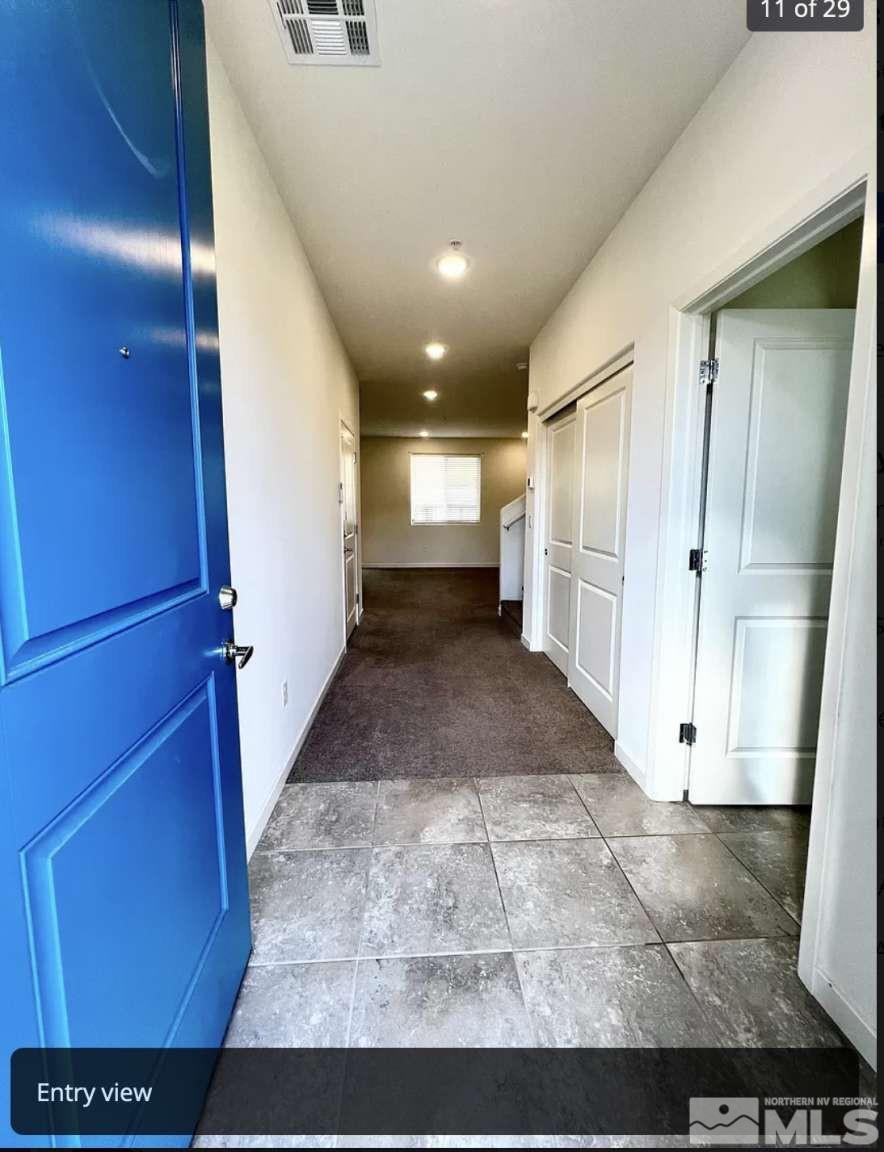 4880 Little Rock Way Sun Valley, NV 89433 - Photo 5 of 30 a view of a hallway with wooden shelves
