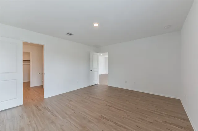 a kitchen with a sink a refrigerator and wooden floor