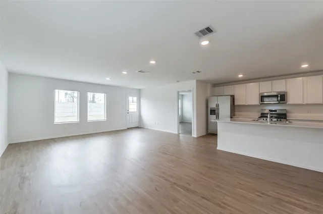 a view of an empty room and wooden floor