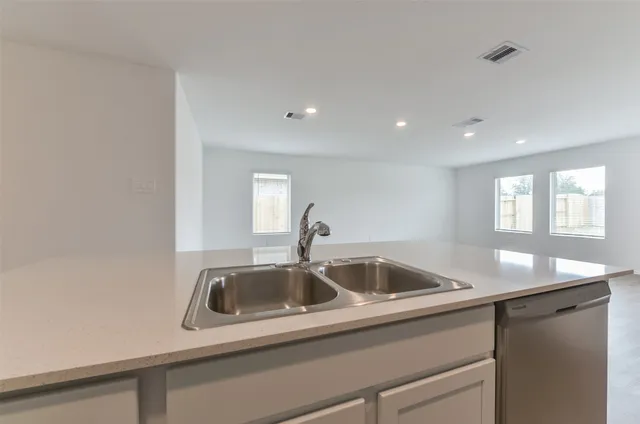 a kitchen with a sink and cabinets