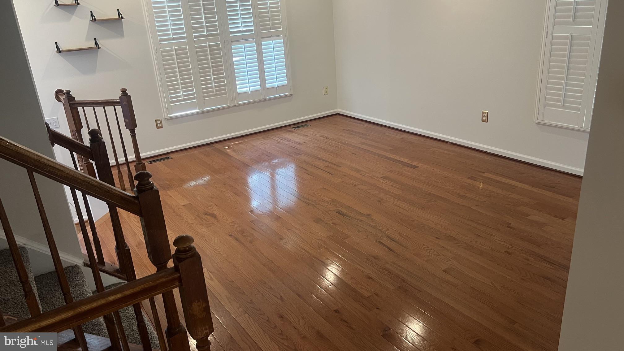 Spacious room with gleaming floors.