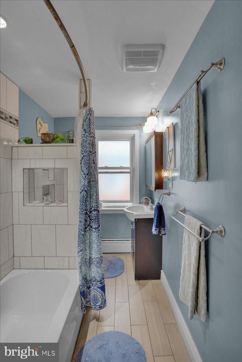 136 West Elm Street Reading, PA 19607 - Photo 14 of 23 a bathroom with a tub a sink and mirror