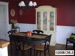 8313 Strandhill Road Huntersville, NC 28078 - Photo 5 of 8 a view of a dining room with furniture and chandelier
