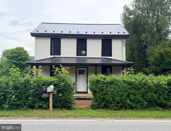 a view of a house with a yard and plants