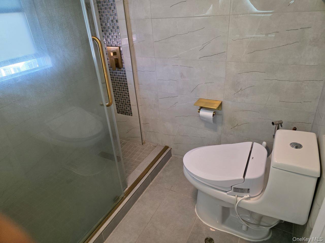 30 Aberdeen Road New Hyde Park, NY 11040 - Photo 26 of 37 a bathroom with a sink and mirror with toilet